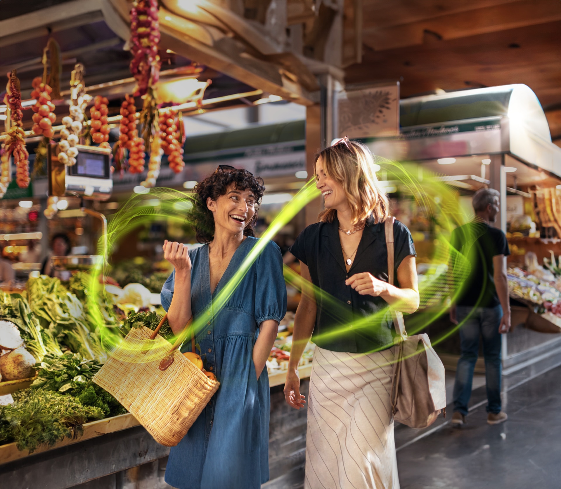 Two women at th market laughing