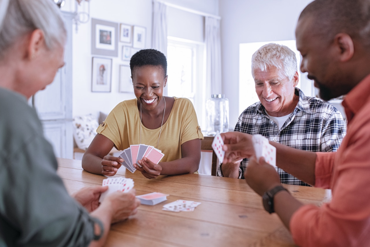 A group of friends spending time together playing cards happy family playing cards