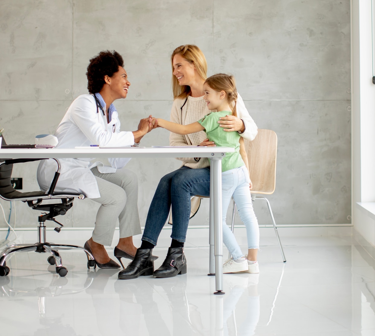 Cute little girl with her mother at the pediatrician examination by African american female doctor; Shutterstock ID 2069126366; purchase_order: -; job: -; client: -; other: -