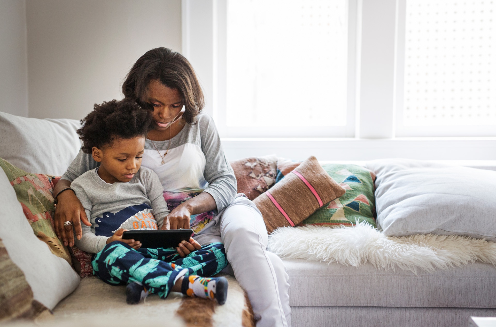 Mother and son playing on a tablet together