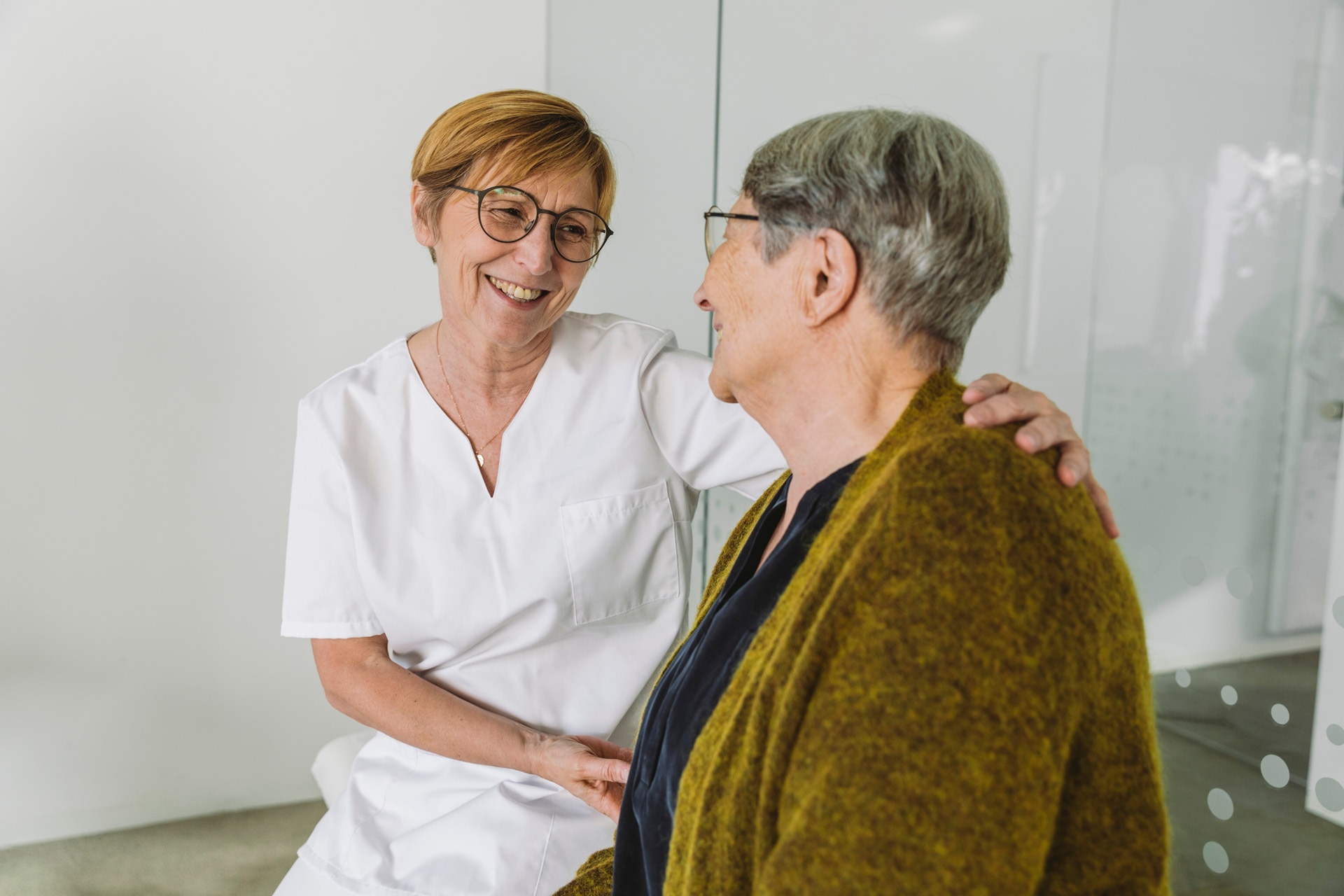 Doctor's assistant encouraging senior patient in medical practice