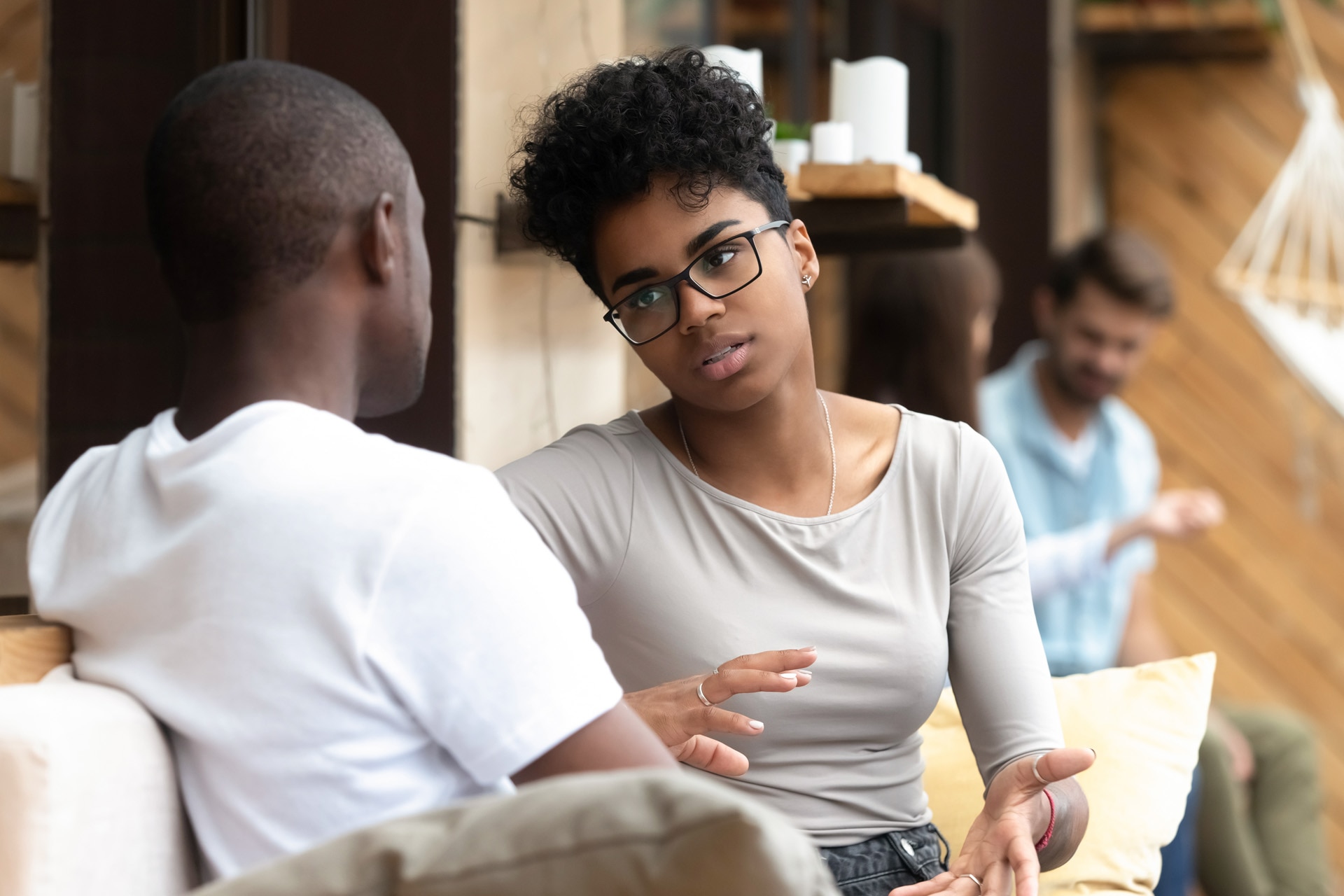 Male and female friends talking in a café.