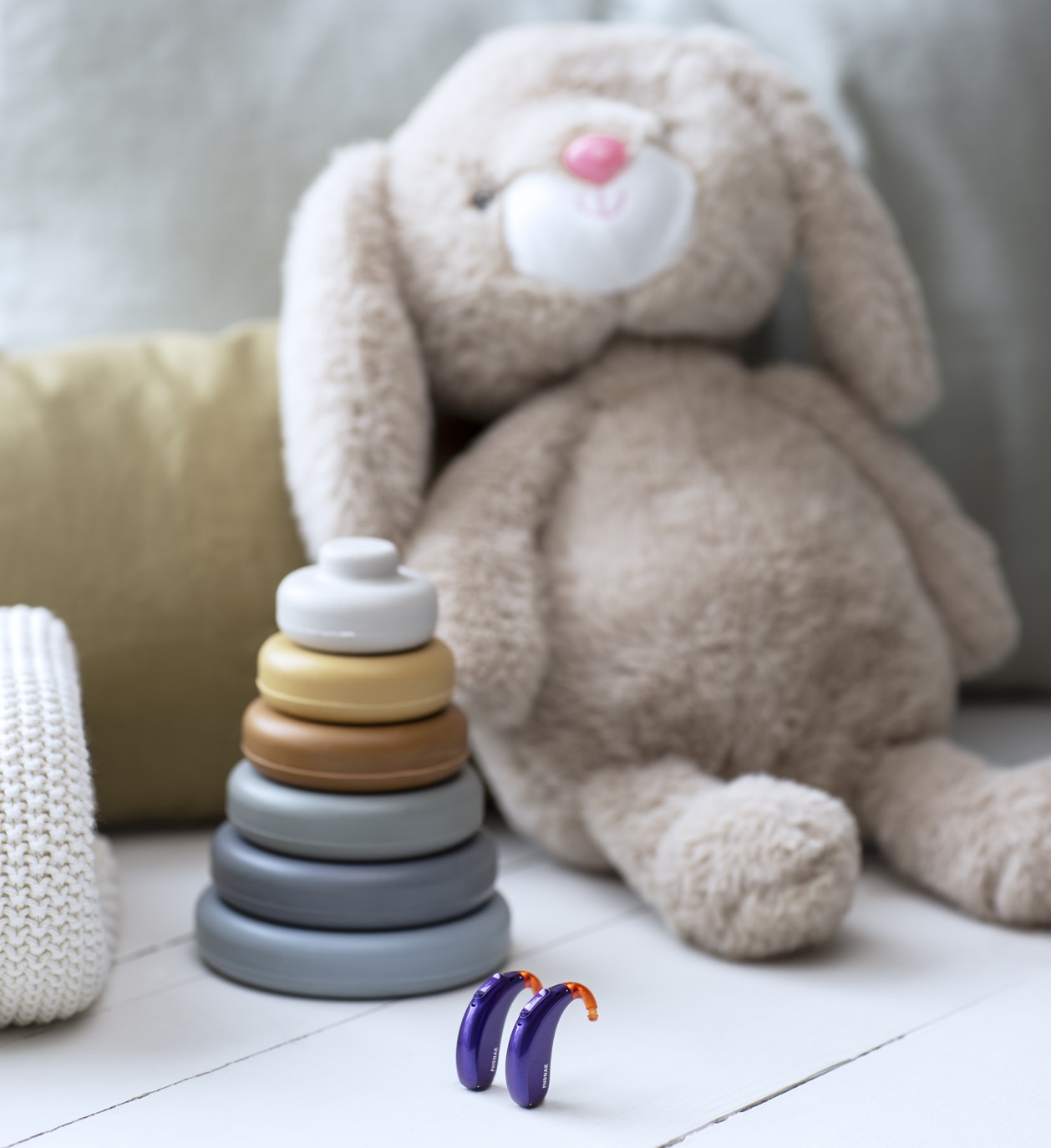 Hearing aids near stuffed animal and baby toy. Høreapparater tæt på tøjdyr og babylegetøj