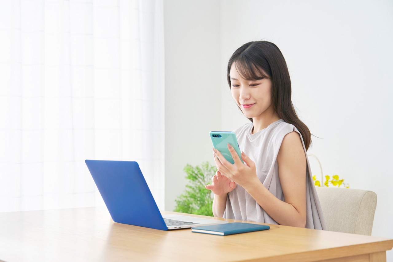 Asian woman using the smartphone at home Asian woman using the smartphone at home