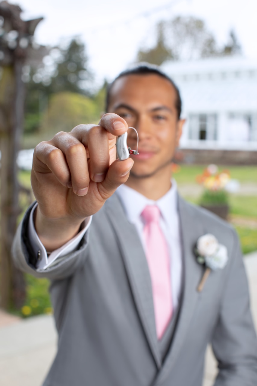 Man holding Audéo Lumity Hearing Aids