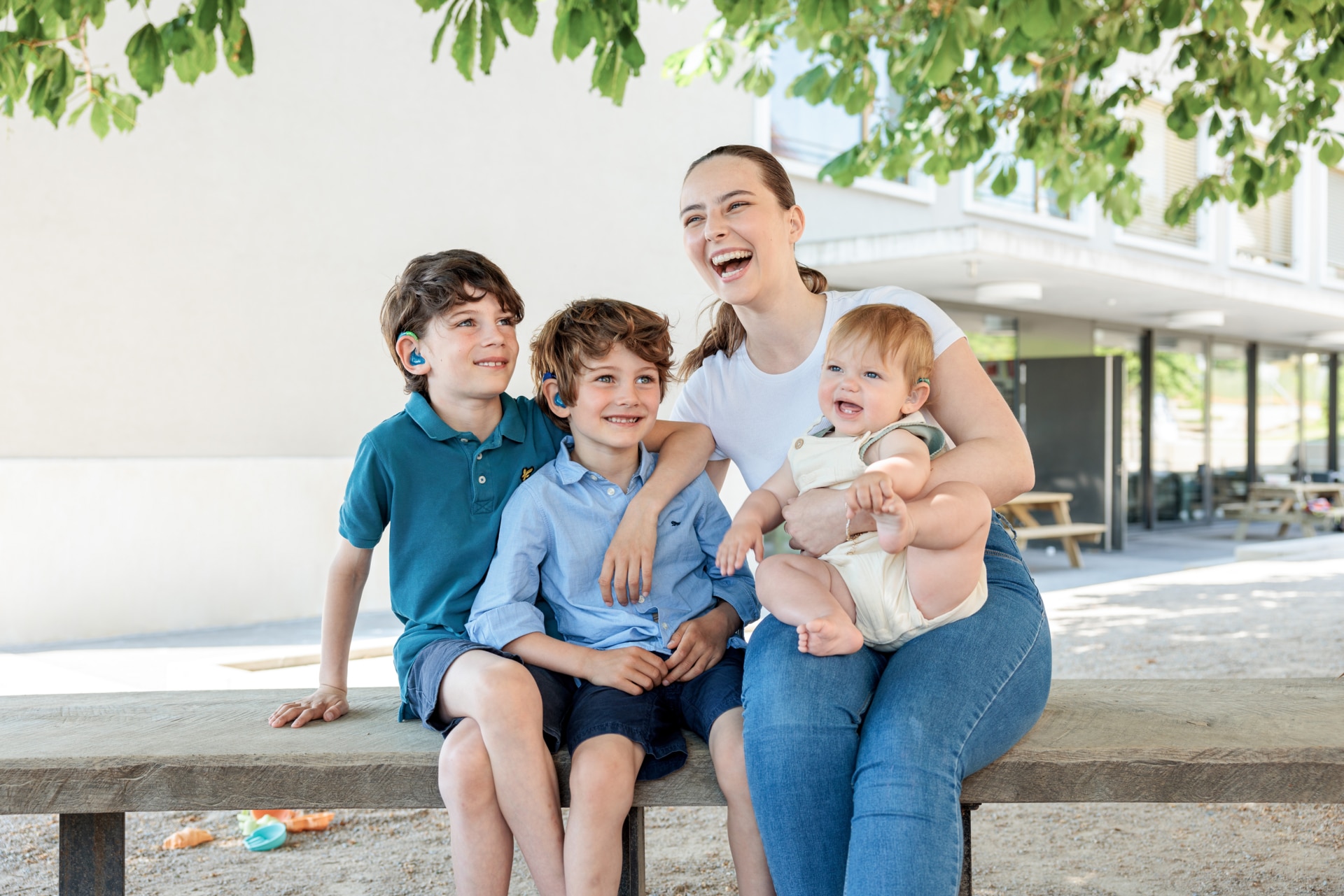 Mom on a bench with her three children